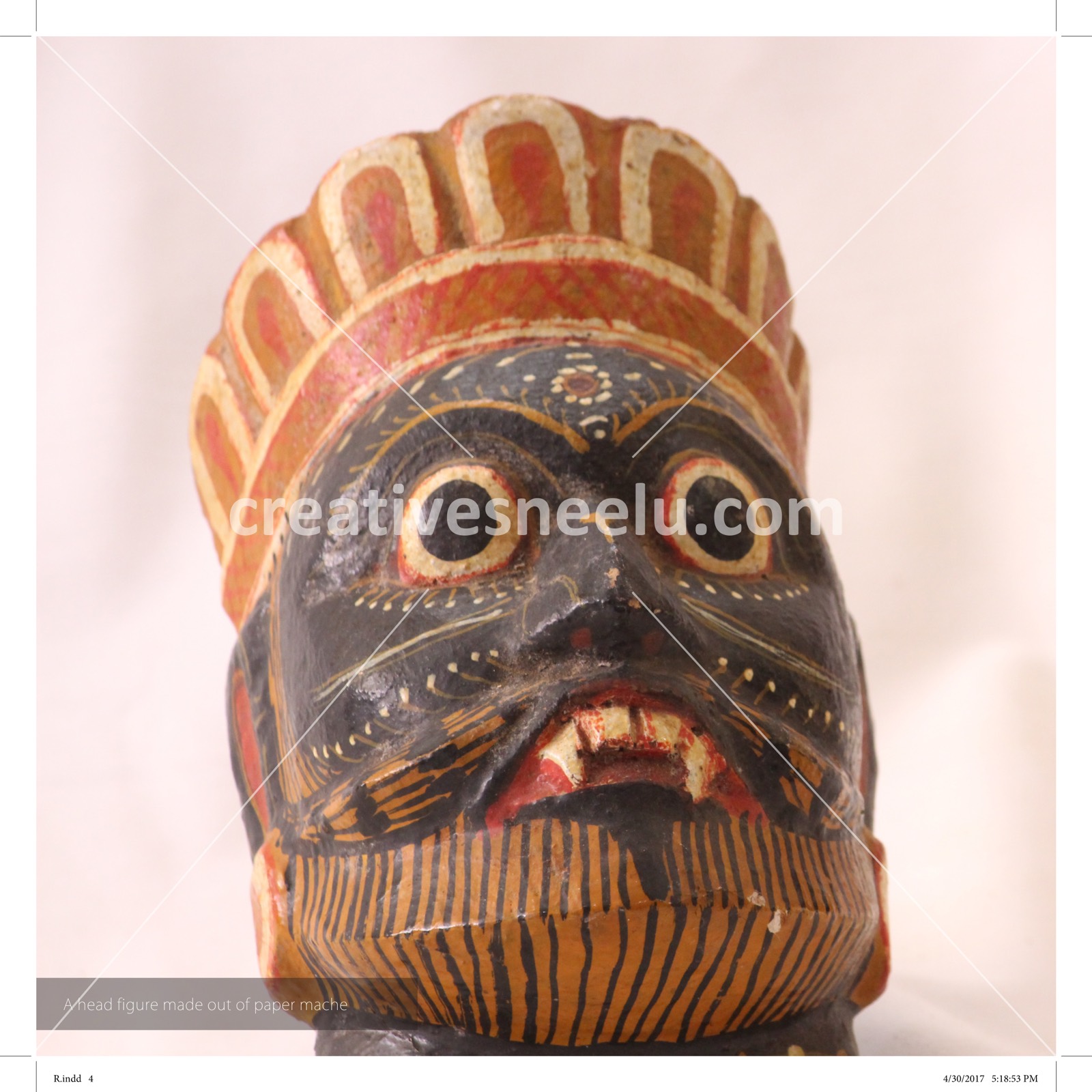 A head figure made out of paper mache