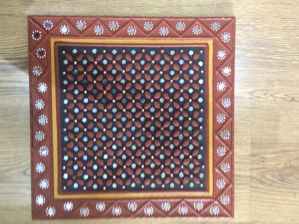 Red mud art with orange boder